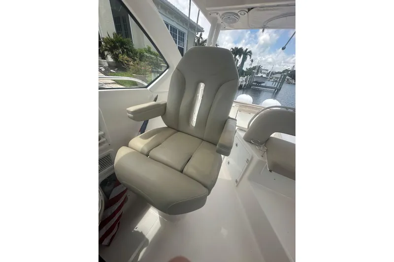 Slide: The Image of Captain's chair on 2016 Pursuit OS 325 Offshore boat, with marina view. - 9
