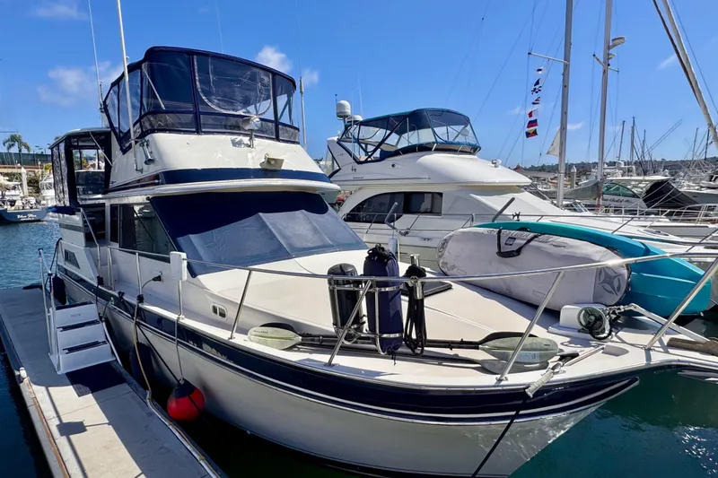 The Image of 1985 Californian 35 Motor Yacht docked at marina, featuring sleek design and spacious deck. - 0