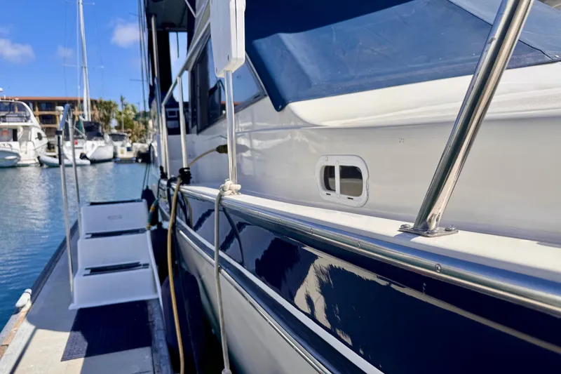Slide: The Image of 1985 Californian 35 Motor Yacht docked in a marina, showcasing sleek design and polished railings. - 10