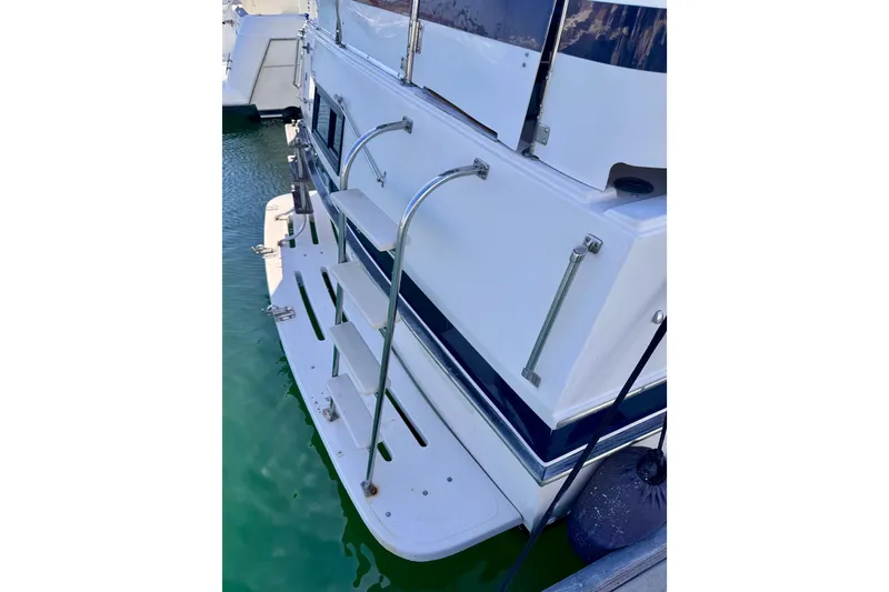 Slide: The Image of 1985 Californian 35 Motor Yacht stern view with swim platform and ladder. - 15