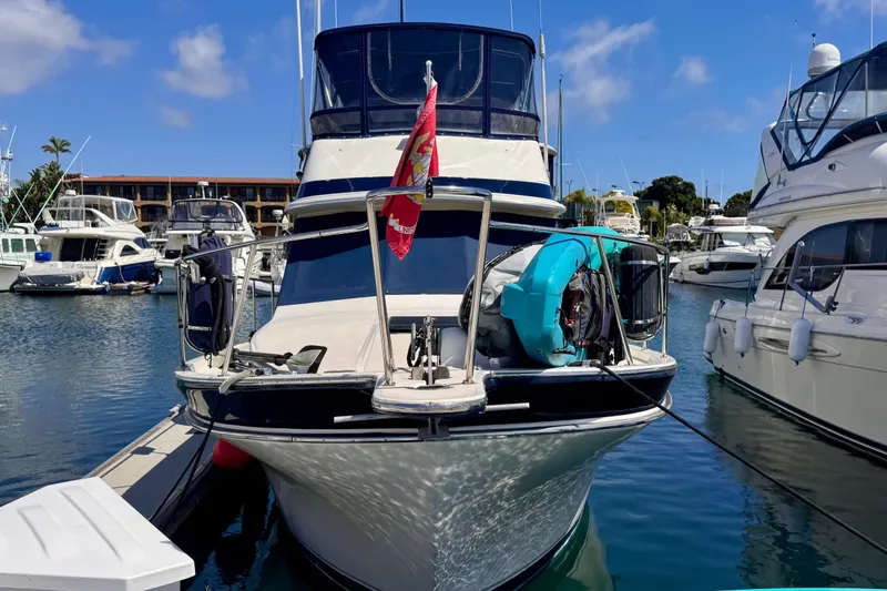 Slide: The Image of 1985 Californian 35 Motor Yacht docked in a marina, surrounded by other boats. - 2