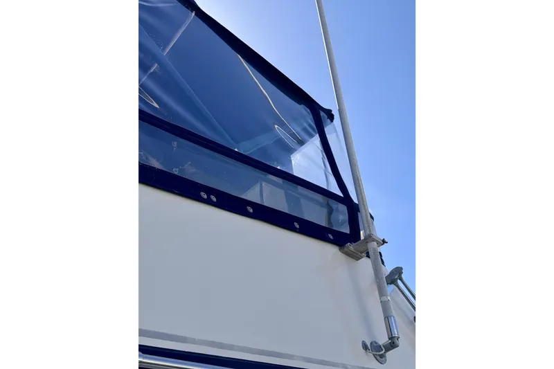 Slide: The Image of 1985 Californian 35 Motor Yacht with blue canopy and railing against clear sky. - 21