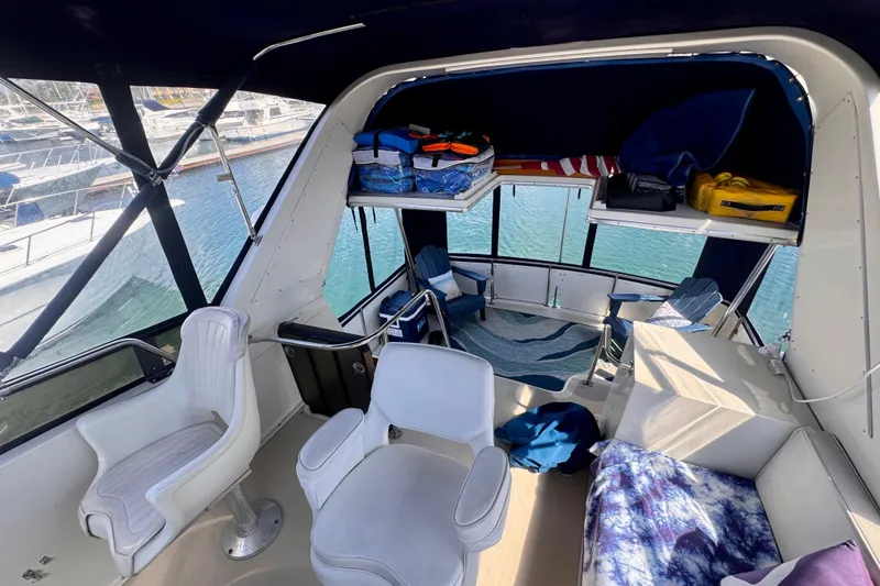 Slide: The Image of Interior of 1985 Californian 35 Motor Yacht with seating and storage, docked at marina. - 31