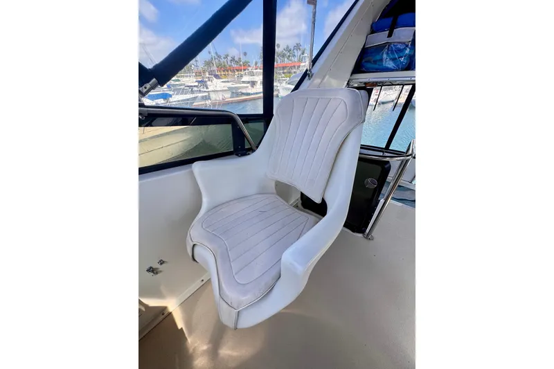 Slide: The Image of White captain's chair on 1985 Californian 35 Motor Yacht, overlooking marina. - 33