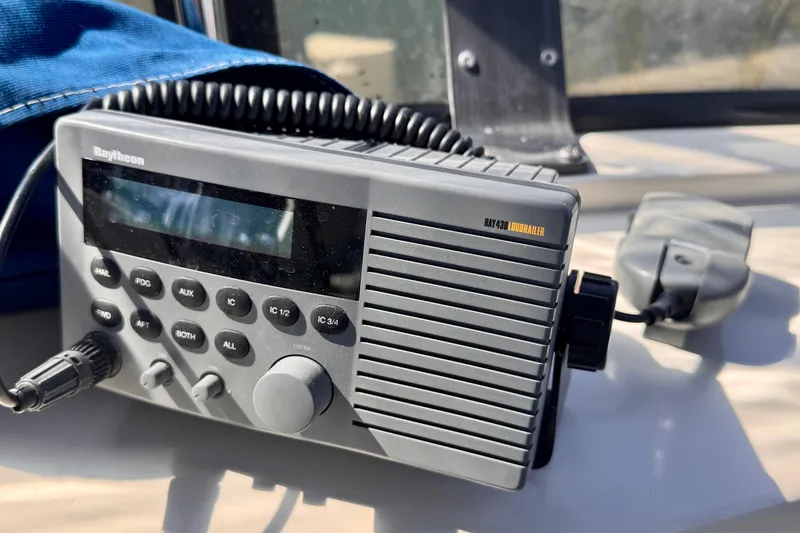 Slide: The Image of Raytheon marine radio on 1985 Californian 35 Motor Yacht, featuring control buttons and microphone. - 34
