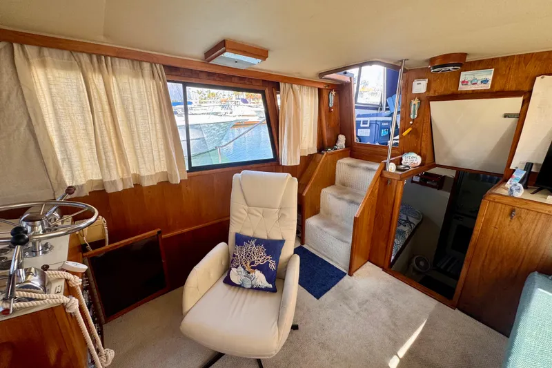 Slide: The Image of Interior of a 1985 Californian 35 Motor Yacht with cozy seating and nautical decor. - 49