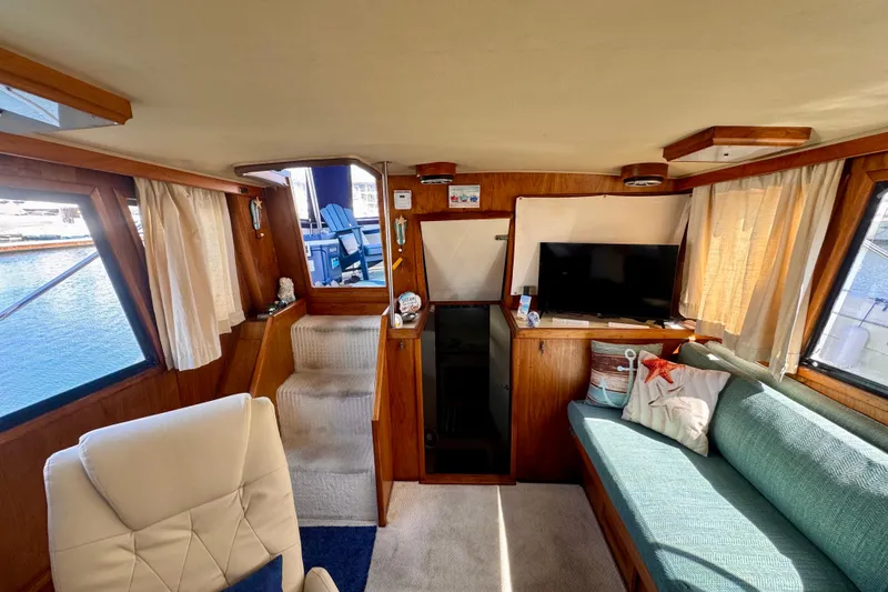 Slide: The Image of Interior of 1985 Californian 35 Motor Yacht with cozy seating and nautical decor. - 50