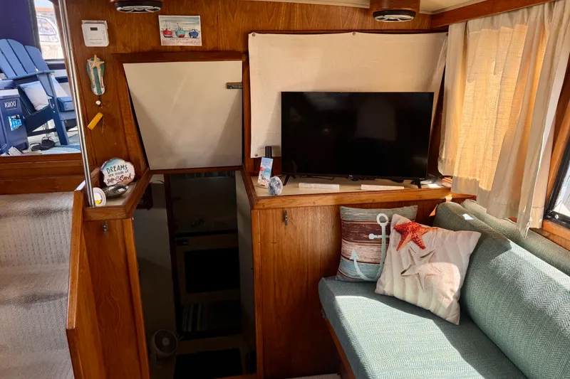 Slide: The Image of Interior of 1985 Californian 35 Motor Yacht with cozy seating and decor. - 51