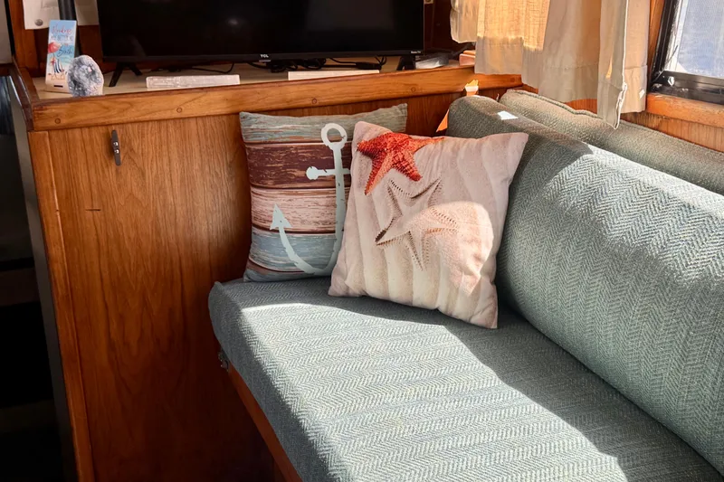 Slide: The Image of Cozy interior of 1985 Californian 35 Motor Yacht with nautical-themed cushions. - 53