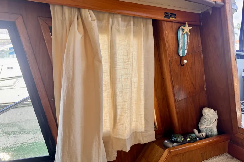 Slide: The Image of Interior of 1985 Californian 35 Motor Yacht with curtain and decorative items. - 57