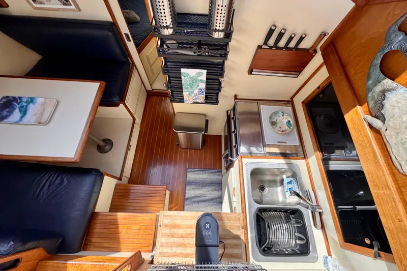Slide: The Image of Interior of 1985 Californian 35 Motor Yacht with kitchen and dining area. - 62