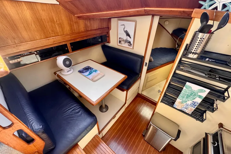 Slide: The Image of Interior of 1985 Californian 35 Motor Yacht with cozy seating and dining area. - 63