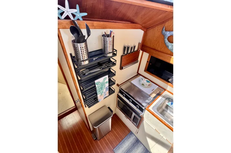 Slide: The Image of Galley kitchen in 1985 Californian 35 Motor Yacht with modern appliances and wooden accents. - 65