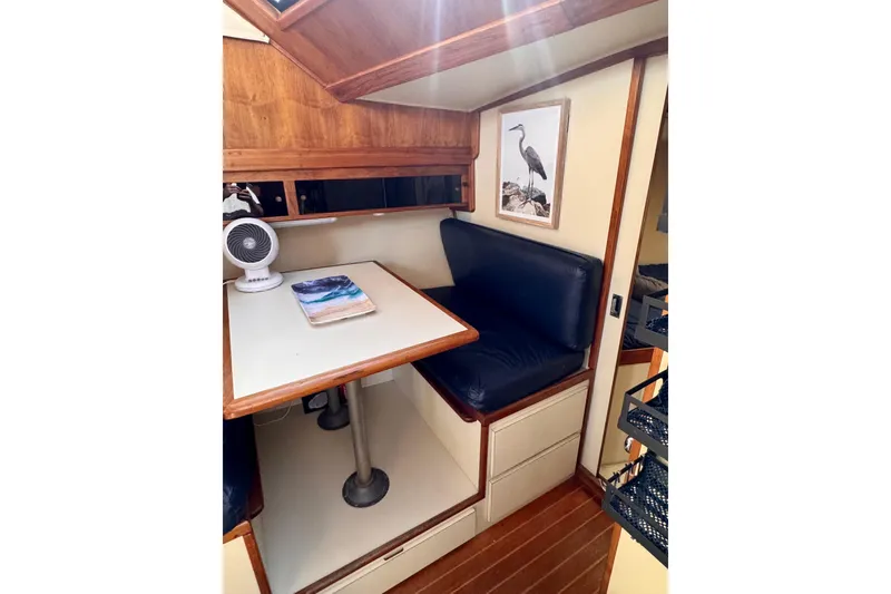 Slide: The Image of Interior of 1985 Californian 35 Motor Yacht with cozy dining area and nautical decor. - 66