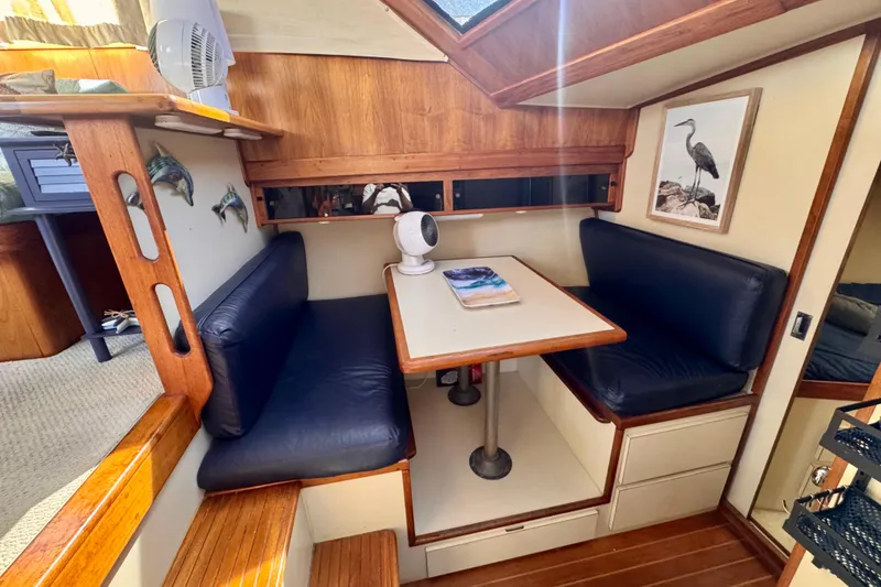 Slide: The Image of Interior of 1985 Californian 35 Motor Yacht with cozy dining area and nautical decor. - 68