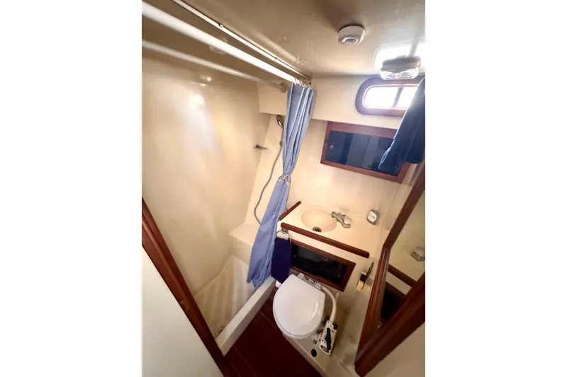 Slide: The Image of 1985 Californian 35 Motor Yacht bathroom with shower, sink, and toilet. - 71