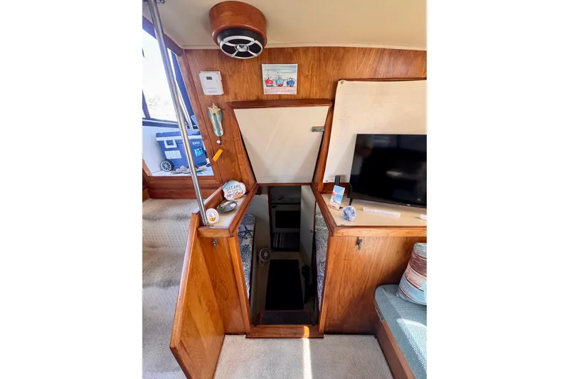 Slide: The Image of Interior of 1985 Californian 35 Motor Yacht with wooden paneling and open hatch. - 74