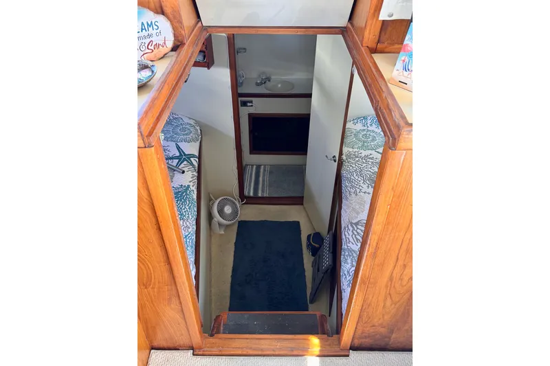 Slide: The Image of Interior view of 1985 Californian 35 Motor Yacht cabin with wooden accents. - 75