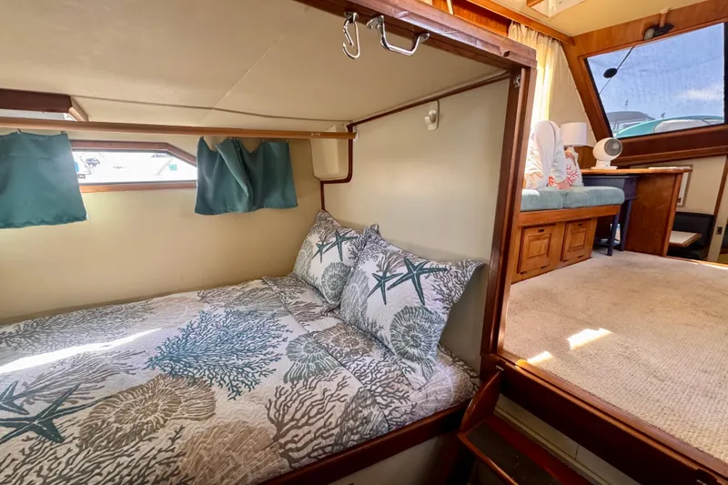 Slide: The Image of Interior of 1985 Californian 35 Motor Yacht with cozy bed and seating area. - 76