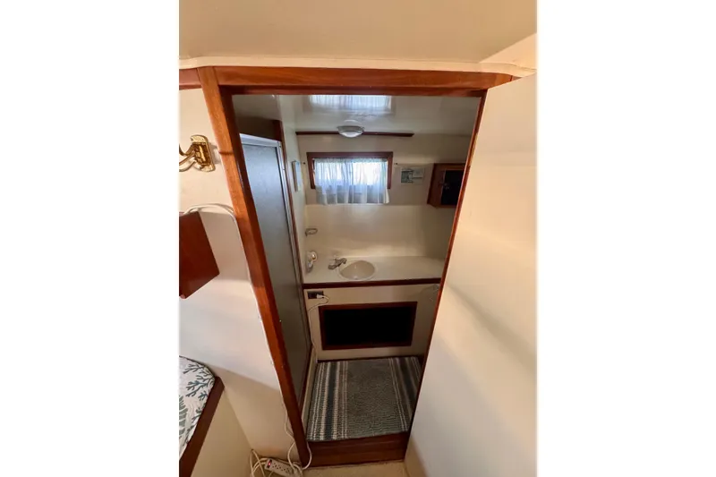 Slide: The Image of Interior of 1985 Californian 35 Motor Yacht bathroom with sink and window. - 79