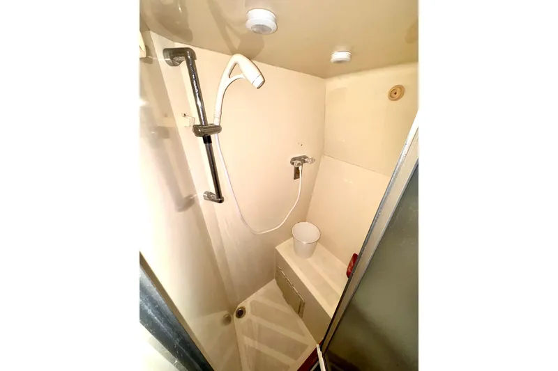 Slide: The Image of Shower area in 1985 Californian 35 Motor Yacht, featuring handheld showerhead and compact design. - 81