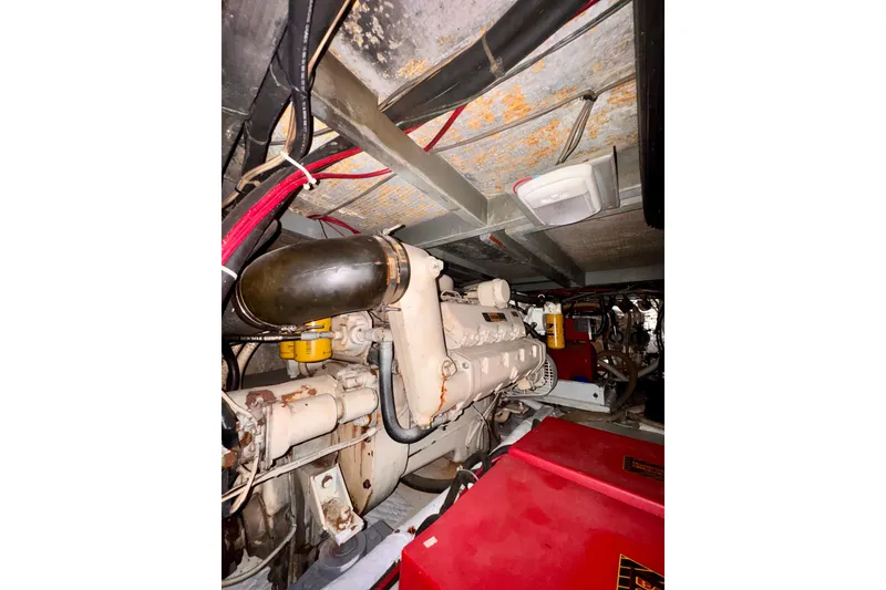 Slide: The Image of Engine room of 1985 Californian 35 Motor Yacht, showcasing mechanical components and wiring. - 86
