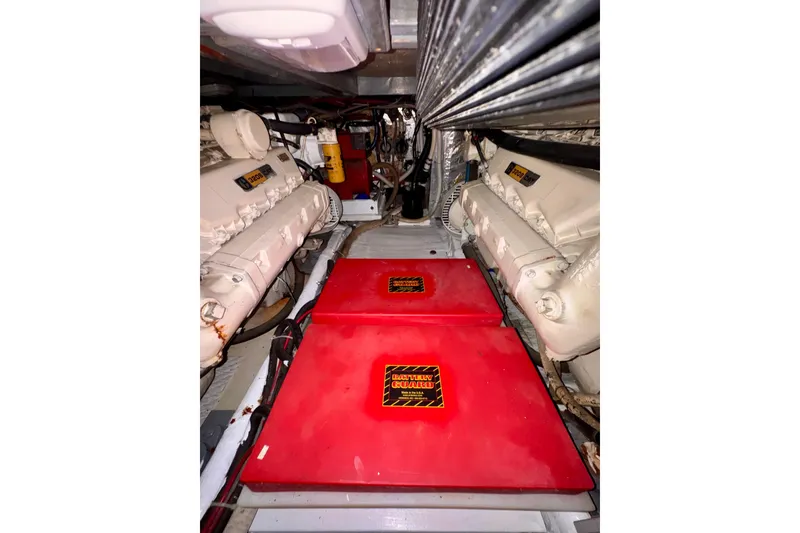 Slide: The Image of Engine room of 1985 Californian 35 Motor Yacht with red battery covers and dual engines. - 87