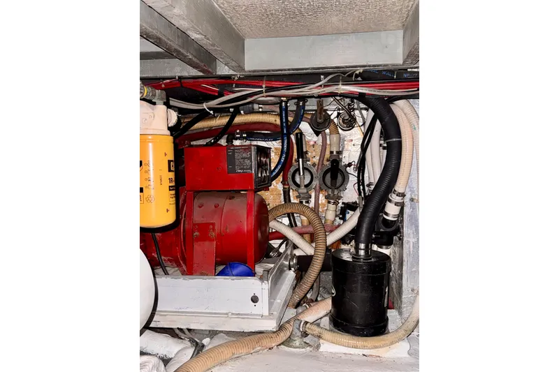Slide: The Image of Engine room of a 1985 Californian 35 Motor Yacht with visible machinery and hoses. - 91