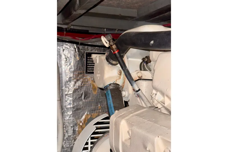 Slide: The Image of Engine compartment of a 1985 Californian 35 Motor Yacht, showing hoses and components. - 93