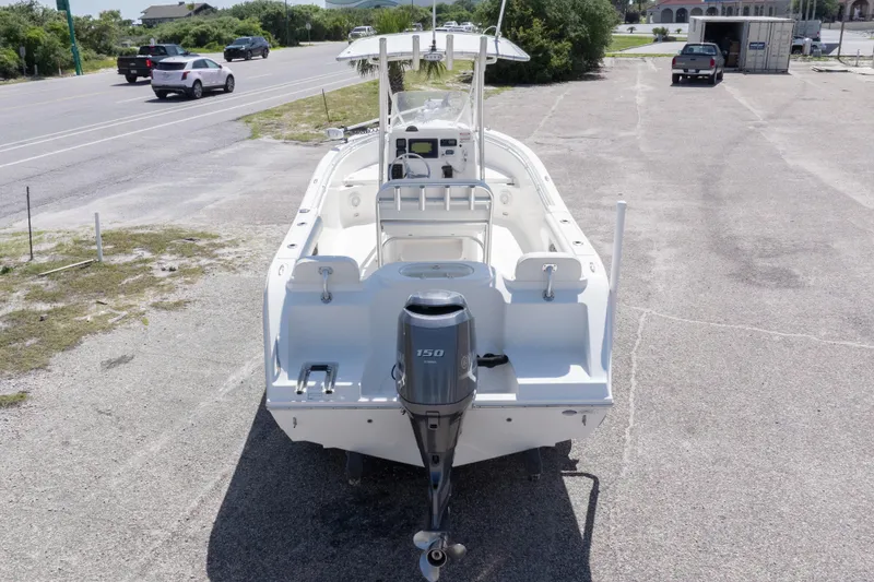 Slide: The Image of 2014 Cobia 214 Center Console boat with outboard motor in parking lot. - 11