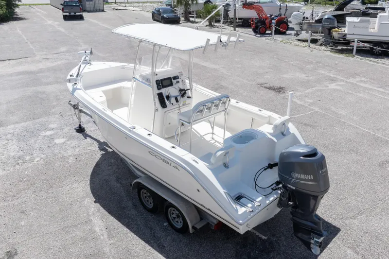 Slide: The Image of 2014 Cobia 214 Center Console boat with Yamaha outboard motor on trailer. - 12