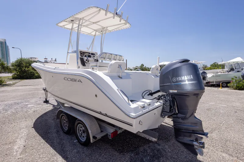 Slide: The Image of 2014 Cobia 214 Center Console boat with Yamaha engine on trailer. - 17