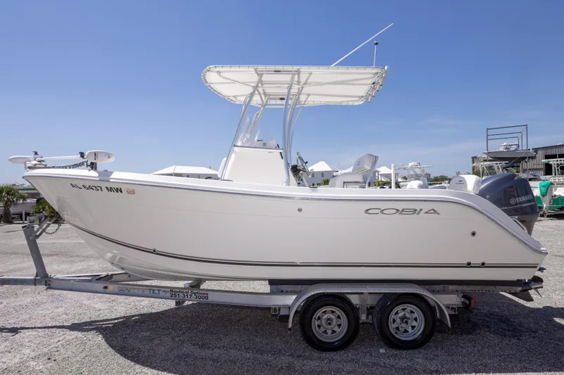 Slide: The Image of 2014 Cobia 214 Center Console boat on trailer, side view, clear sky background. - 18