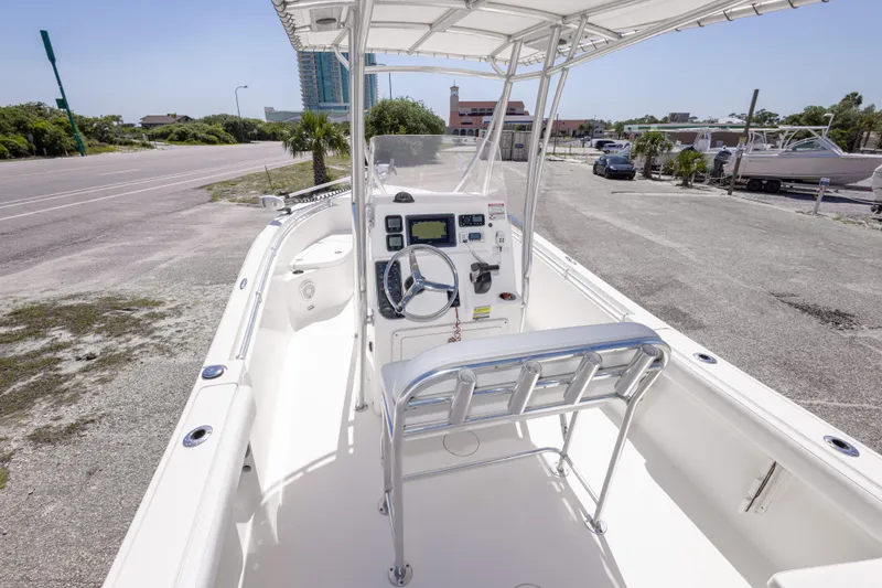 Slide: The Image of 2014 Cobia 214 Center Console boat with steering wheel and navigation equipment. - 22