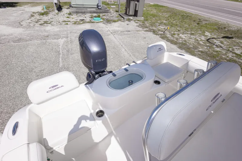 Slide: The Image of 2014 Cobia 214 Center Console boat with Yamaha 150 engine, featuring spacious seating and storage. - 25