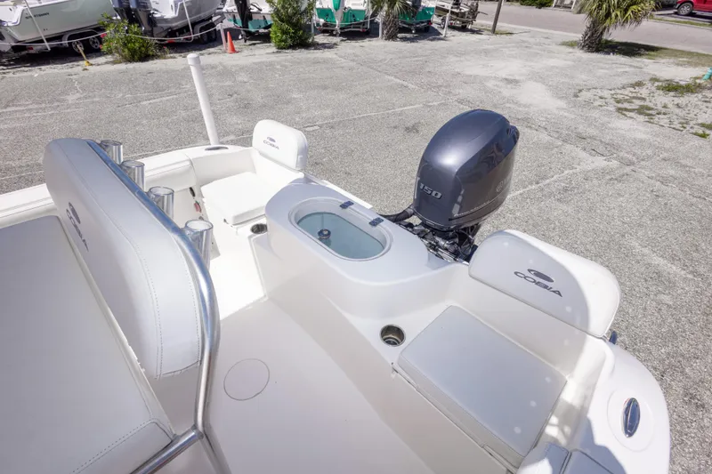 Slide: The Image of 2014 Cobia 214 Center Console boat with Yamaha 150 engine, docked outdoors. - 26