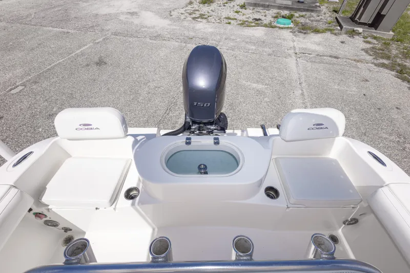 Slide: The Image of 2014 Cobia 214 Center Console boat with seating and outboard motor, viewed from above. - 27