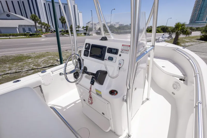 Slide: The Image of 2014 Cobia 214 Center Console boat interior with steering wheel and control panel. - 28