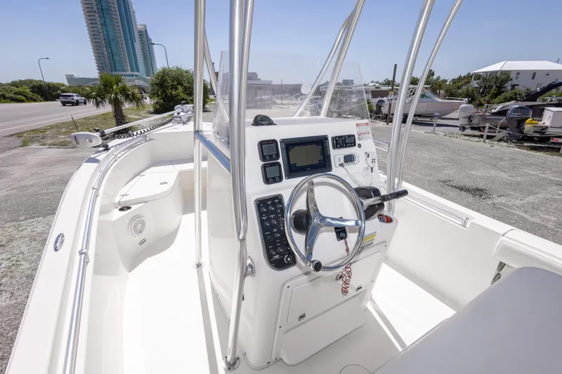Slide: The Image of 2014 Cobia 214 Center Console boat with modern dashboard and steering wheel. - 29