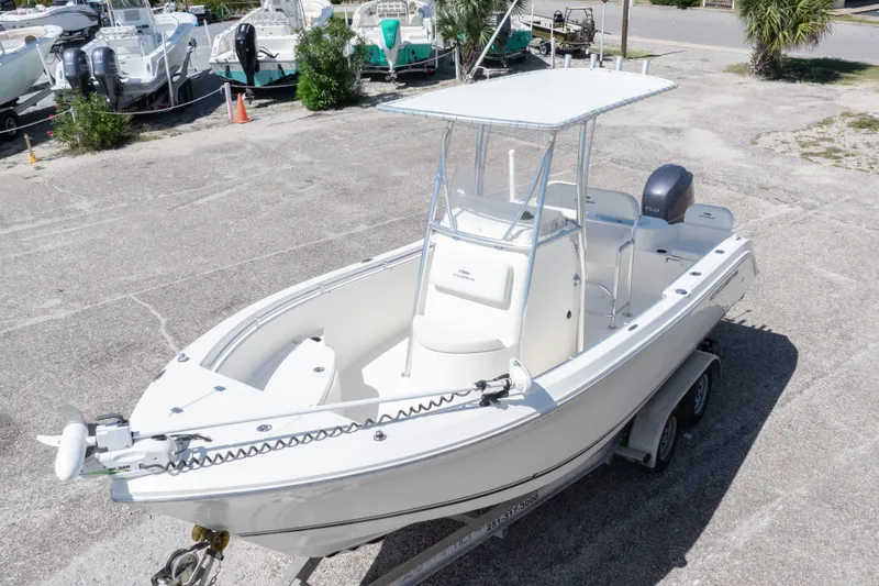 Slide: The Image of 2014 Cobia 214 Center Console boat on trailer, parked outdoors. - 3