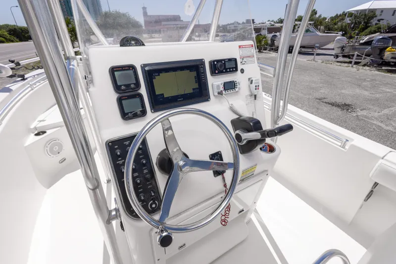 Slide: The Image of 2014 Cobia 214 Center Console boat dashboard with steering wheel and navigation equipment. - 30