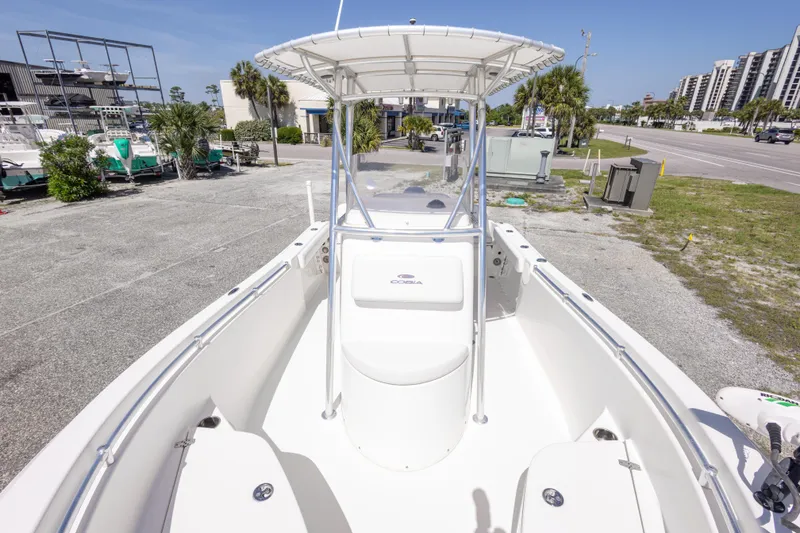 Slide: The Image of 2014 Cobia 214 Center Console boat on display in a marina setting. - 38