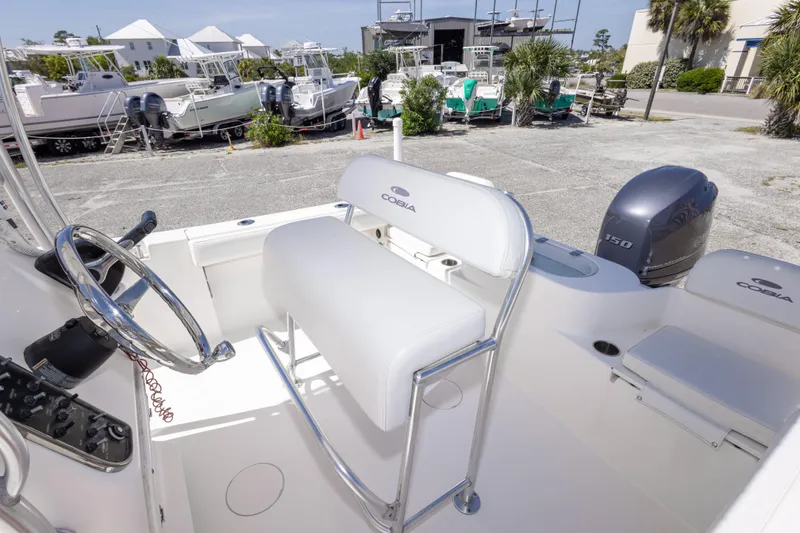 Slide: The Image of 2014 Cobia 214 Center Console boat with Yamaha 150 engine, docked in a marina. - 41