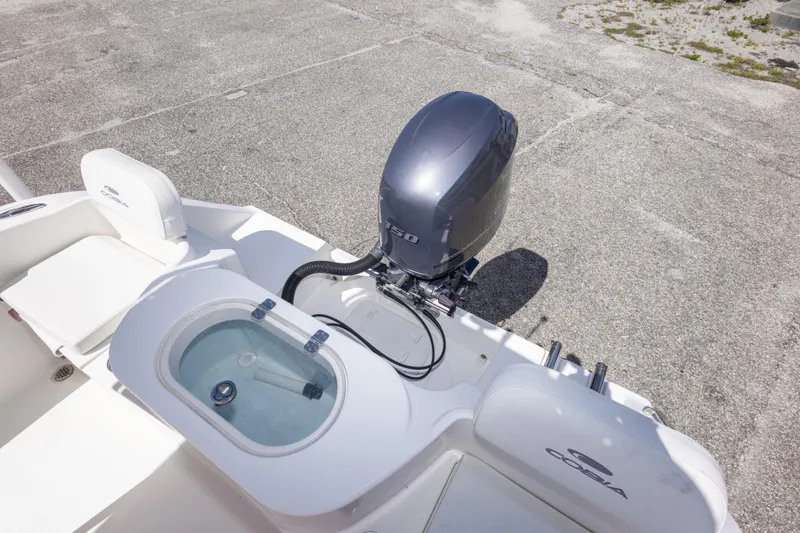 Slide: The Image of 2014 Cobia 214 Center Console boat with outboard motor and livewell on deck. - 42