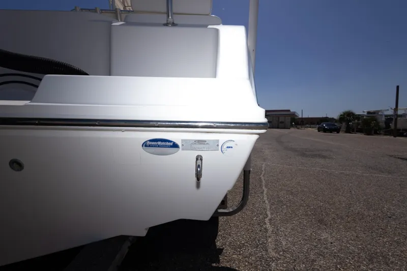 Slide: The Image of 2014 Cobia 214 Center Console boat rear view in a parking area. - 46