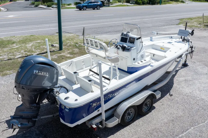 Slide: The Image of 2015 NauticStar 214 XTS boat on trailer with Yamaha outboard motor. - 13