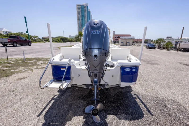 Slide: The Image of 2015 NauticStar 214 XTS boat with Yamaha 150 engine, parked on a sunny day. - 17