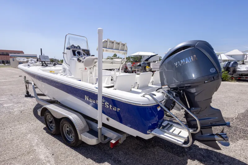 Slide: The Image of 2015 NauticStar 214 XTS boat with Yamaha engine on trailer, parked outdoors. - 18