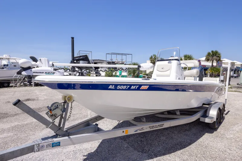 Slide: The Image of 2015 NauticStar 214 XTS boat on trailer, parked outdoors under clear blue sky. - 20