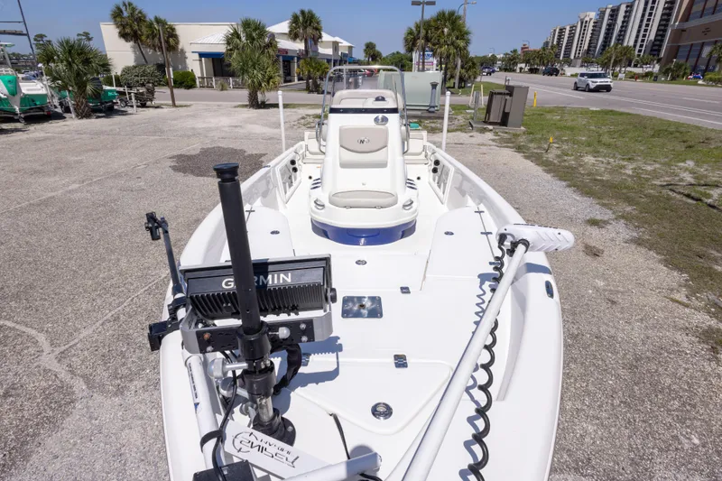 Slide: The Image of 2015 NauticStar 214 XTS boat with Garmin equipment, parked near a road and buildings. - 22